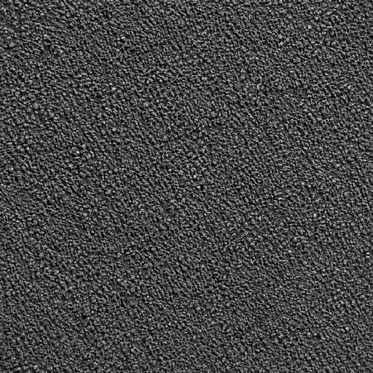 Gros plan d'un grain minéral serré de teinte anthracite